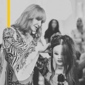 Black and white photo of Vivienne Mackinder teaching a class for hair stylists using a mannaquin